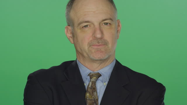 Middle-aged-businessman-looking-upset,-on-a-green-screen-studio-background