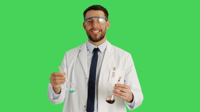 Mid-Shot-of-a-Scientist-Wearing-Protective-Glasses-Mixing-Chemicals-in-a-Beakers.-Background-is-Green-Screen.