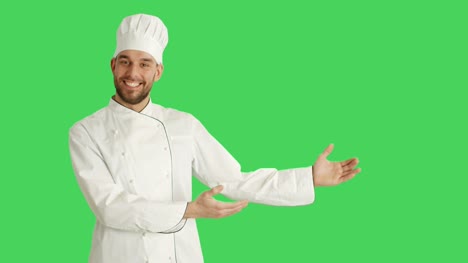 Mitte-Schuss-eines-schönen-Küchenchefs-macht-präsentieren-Geste.-Hintergrund-ist-Green-Screen.