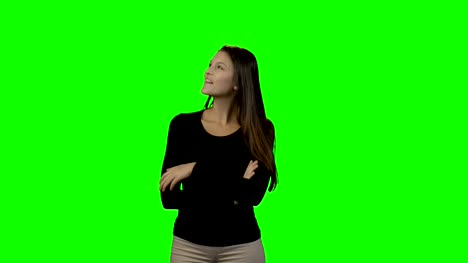 Smiling-woman-looking-around-against-green-screen