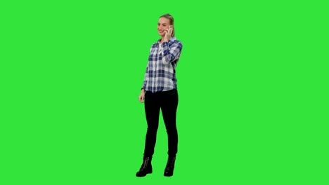 Happy-young-woman-talking-on-mobile-phone-smiling-on-a-Green-Screen,-Chroma-Key