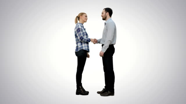 Two-young-people-shake-hands-keep-silent-on-white-background
