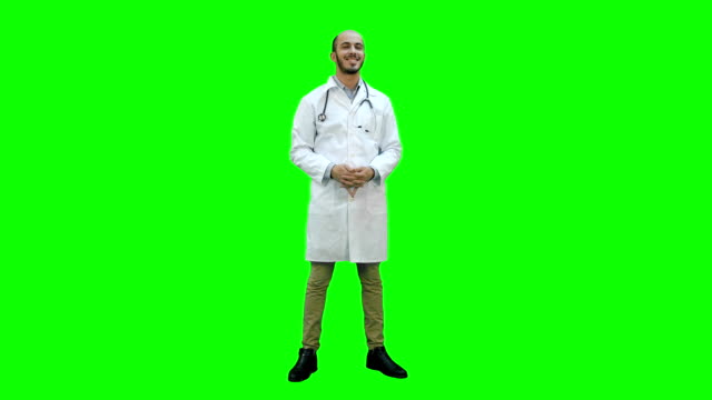 Smiling-doctor-happily-looking-at-the-camera-on-a-Green-Screen,-Chroma-Key