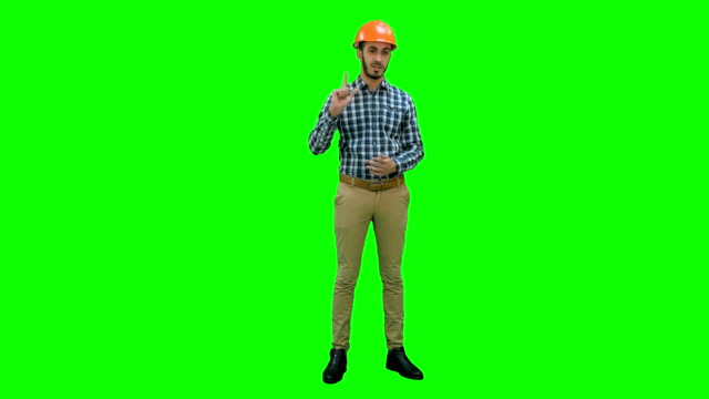 Construction-worker-enlisting-factors-for-success-on-his-fingers-on-a-Green-Screen,-Chroma-Key