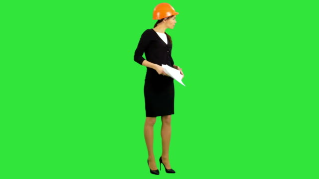 Böse-weibliche-Bauleiter-Unterlagen-und-rief-bei-den-Arbeitern-auf-einem-Green-Screen,-Chroma-Key