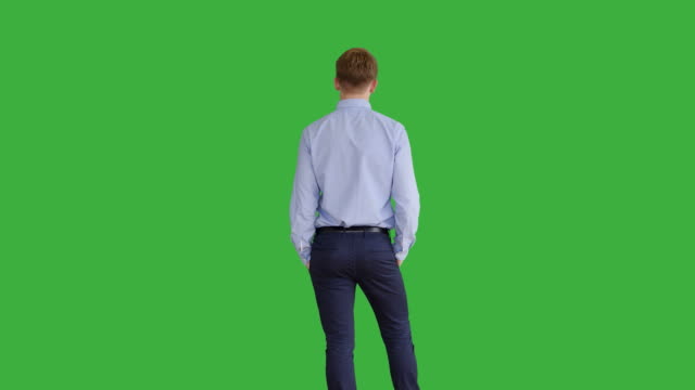 Young-Handsome-Men-Acting-in-Front-of-a-Green-Screen.-Blond-Hair,-Blue-Shirt-and-Blue-Trousers.-Dancing,-Thinking,-Turning-Around-and-Talking-to-the-Camera.