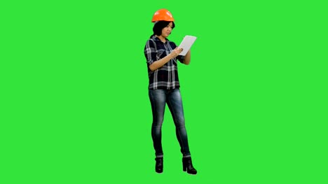 Asian-engineer-woman-using-tablet-on-a-Green-Screen,-Chroma-Key