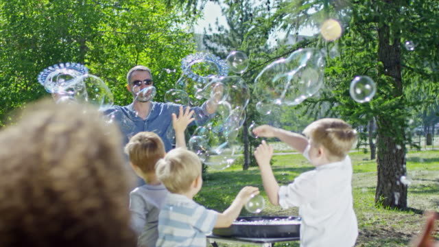 Artista-intérprete-o-ejecutante-soplar-burbujas-para-niños-juguetones-en-el-Parque