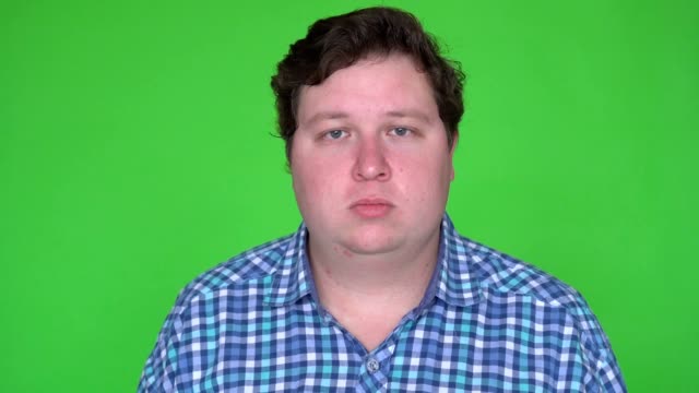 Portrait-of-caucasian-man-with-plaid-shirt-looking-at-camera-with-blank-expression.-Chroma-keying.