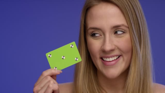 Close-Portrait-of-a-Woman-holding-a-blank-Credit-Card-and-making-thump-up