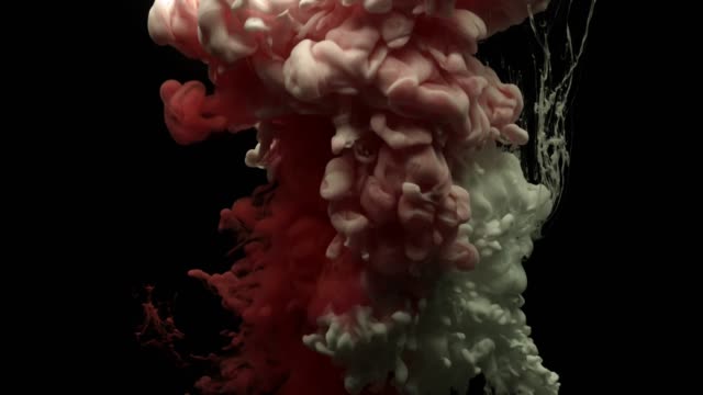 Red-and-white-acrylic-paint-cloud-spraying-in-water-on-black-background.