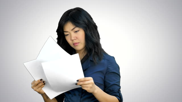 Asian-business-women-looking-document-file-in-her-hand-on-white-background