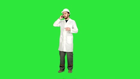 Engineer-talking-on-the-phone-on-a-construction-site-on-a-Green-Screen,-Chroma-Key