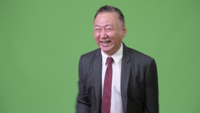 Mature-Japanese-businessman-laughing-out-loud