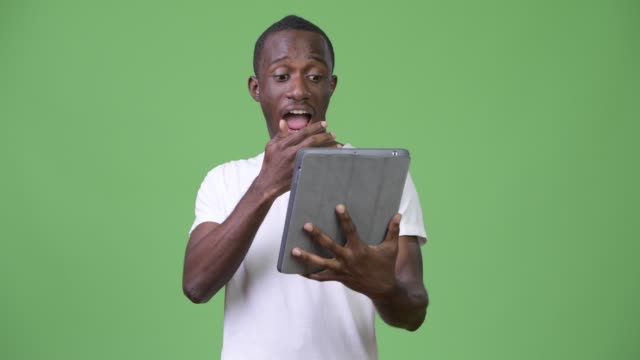 Young-shocked-African-man-using-digital-tablet