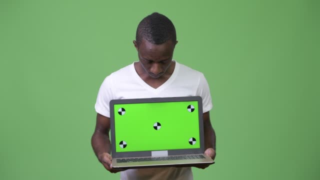 Young-African-man-showing-laptop