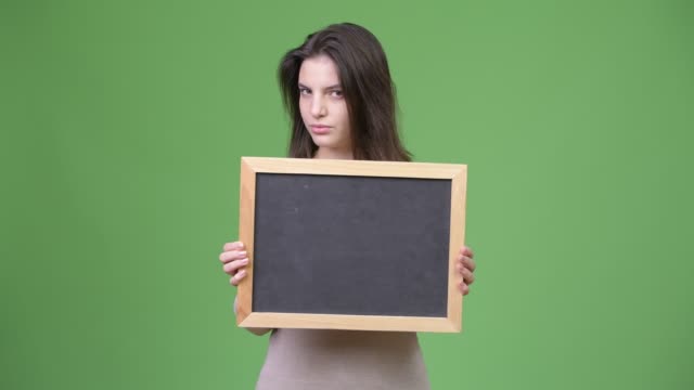 Young-beautiful-woman-nodding-no-while-holding-blackboard