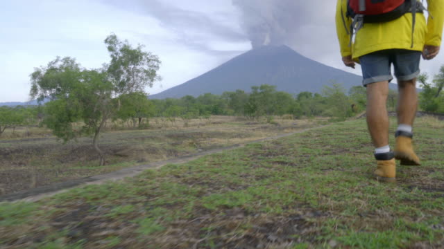 Man-Hiking-in-Bali-near-Erupting-Volcano