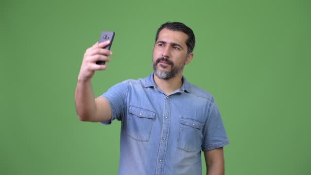 Handsome-Persian-bearded-man-taking-selfie