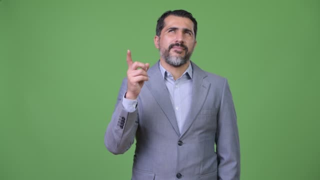 Handsome-Persian-bearded-businessman-pointing-finger-up
