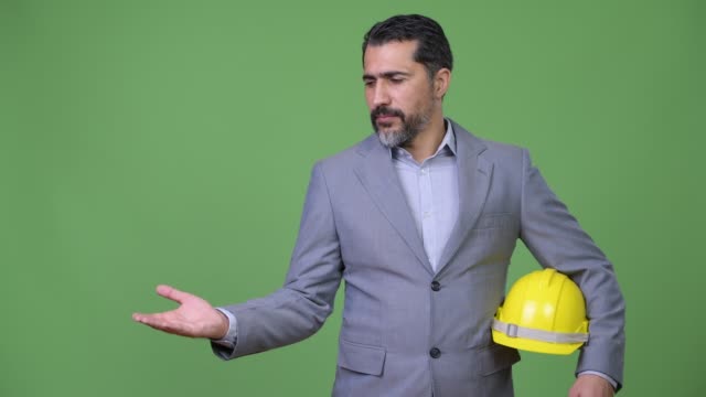 Handsome-Persian-bearded-businessman-as-engineer-showing-something