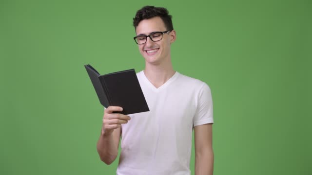 Young-handsome-nerd-man-reading-book