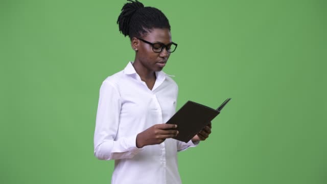 Young-beautiful-African-businesswoman-reading-book