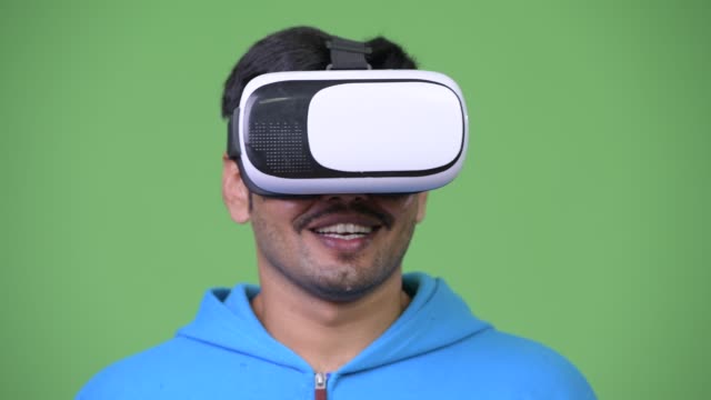 Young-handsome-Persian-man-using-virtual-reality-headset