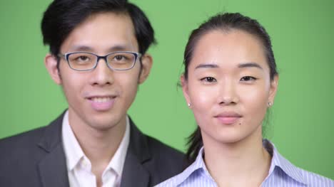 Young-happy-Asian-business-couple-smiling-together