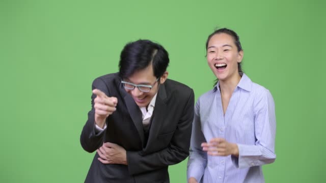 Young-Asian-business-couple-laughing-together