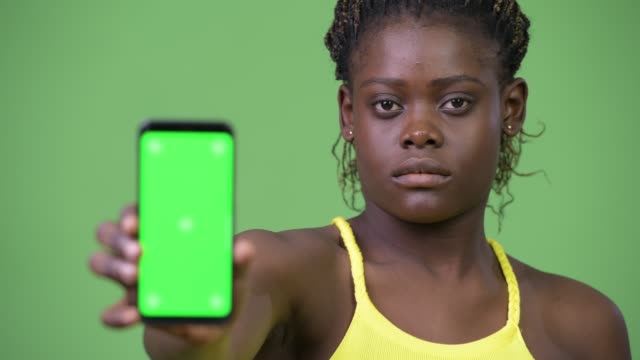Young-African-woman-showing-phone