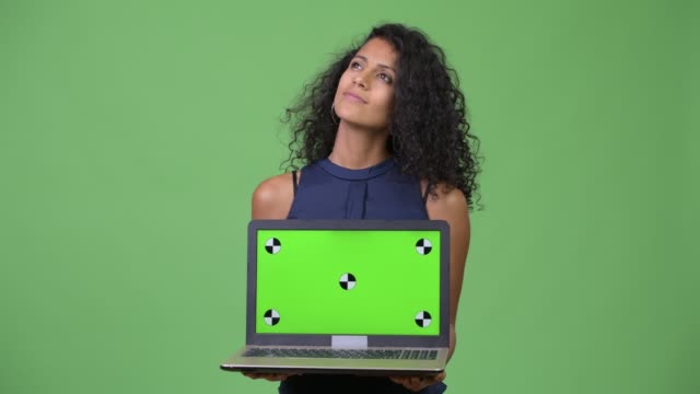 Young-beautiful-Hispanic-businesswoman-showing-laptop