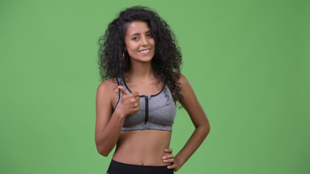 Young-beautiful-Hispanic-woman-with-gym-clothes-giving-thumbs-up