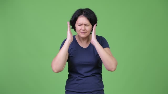 Stressed-woman-covering-ears-from-loud-noise