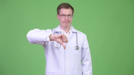 Young-Man-Doctor-Making-Thumb-Down-Gesture