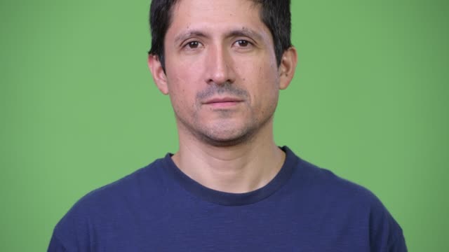 Hispanic-man-against-green-background