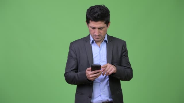 Hispanic-businessman-using-phone