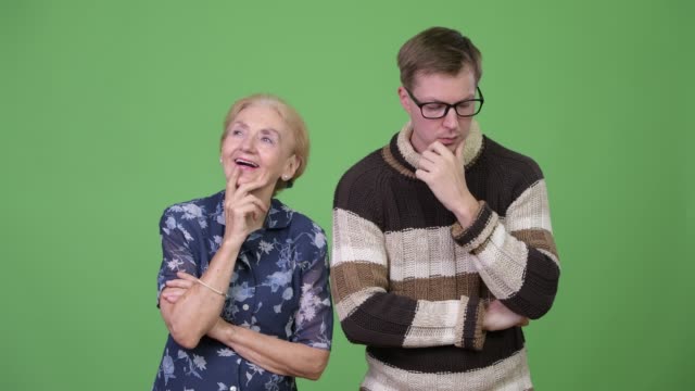 Happy-grandmother-and-worried-grandson-thinking-together