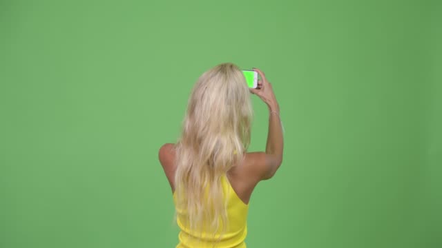 Young-beautiful-blonde-woman-taking-pictures-with-phone