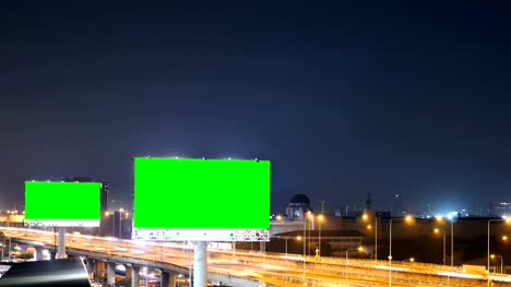 Green-screen-of-advertising-billboard-on-expressway-during-the-twilight-with-city-background-in-Bangkok,-Thailand.