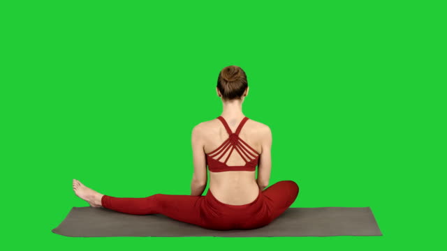 Woman-taking-a-Lotus-pose-on-a-Green-Screen,-Chroma-Key