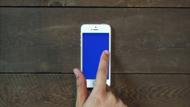 Swipes-Left-Hand-Smartphone-with-Blue-Screen