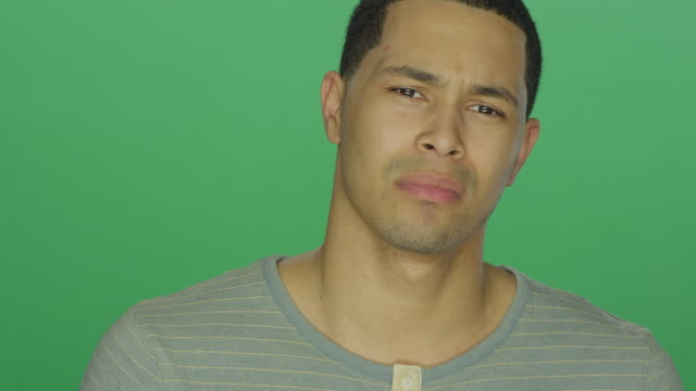 Young-African-American-man-about-to-cry,-on-a-green-screen-background