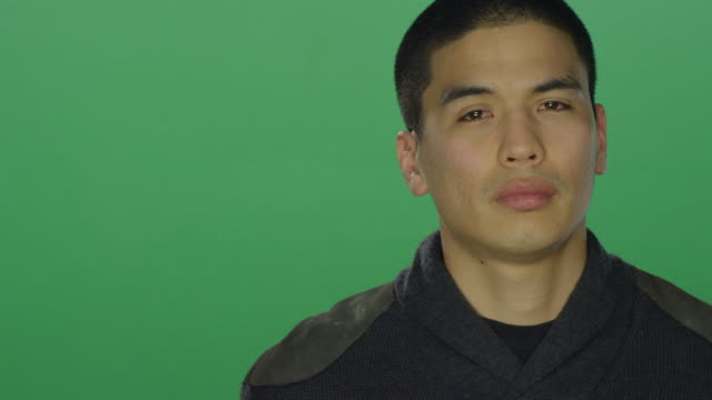 Young-man-looks-sad,-on-a-green-screen-studio-background