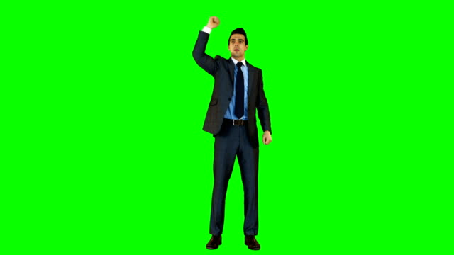 Businessman-gesturing-against-green-background