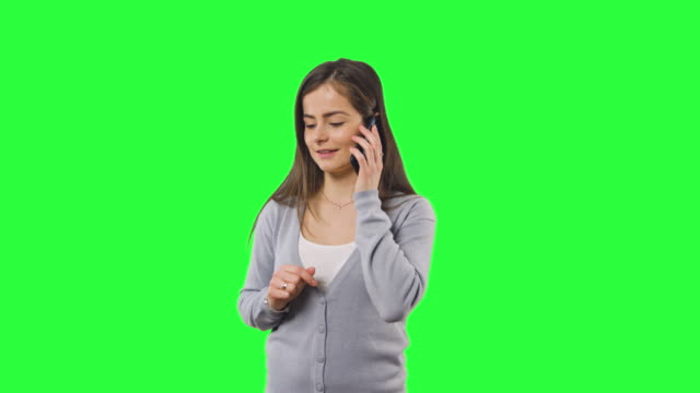 Woman-isolated-on-green-screen-with-phone