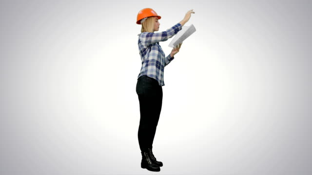 Female-engineer-inspects-construction-site-and-talking-to-workers-to-correct-them-on-white-background