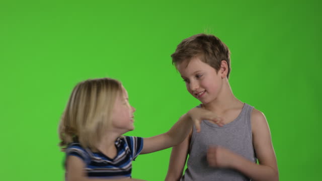 Brothers-playing-together-in-front-of-greenscreen