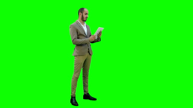 Young-manager-having-video-conference-via-tablet-on-a-Green-Screen,-Chroma-Key