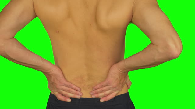 Man-rubbing-by-palm-his-lower-back-due-pain-in-back.-Adult-caucasian-man-back-view.